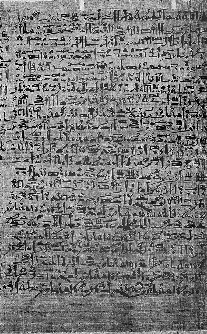 A column of the Edwin Smith Papyrus, dense black hieratic script on grey papyrus